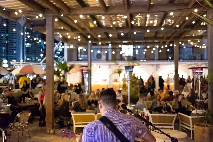 Live music at The Island Rooftop, a popular evening venue with string lights and a lively crowd—one of the standout things to do in Surfers Paradise beyond the beach.